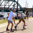 Load image into Gallery viewer, two guys on roller blades playing hockey in Stillwater, MN
