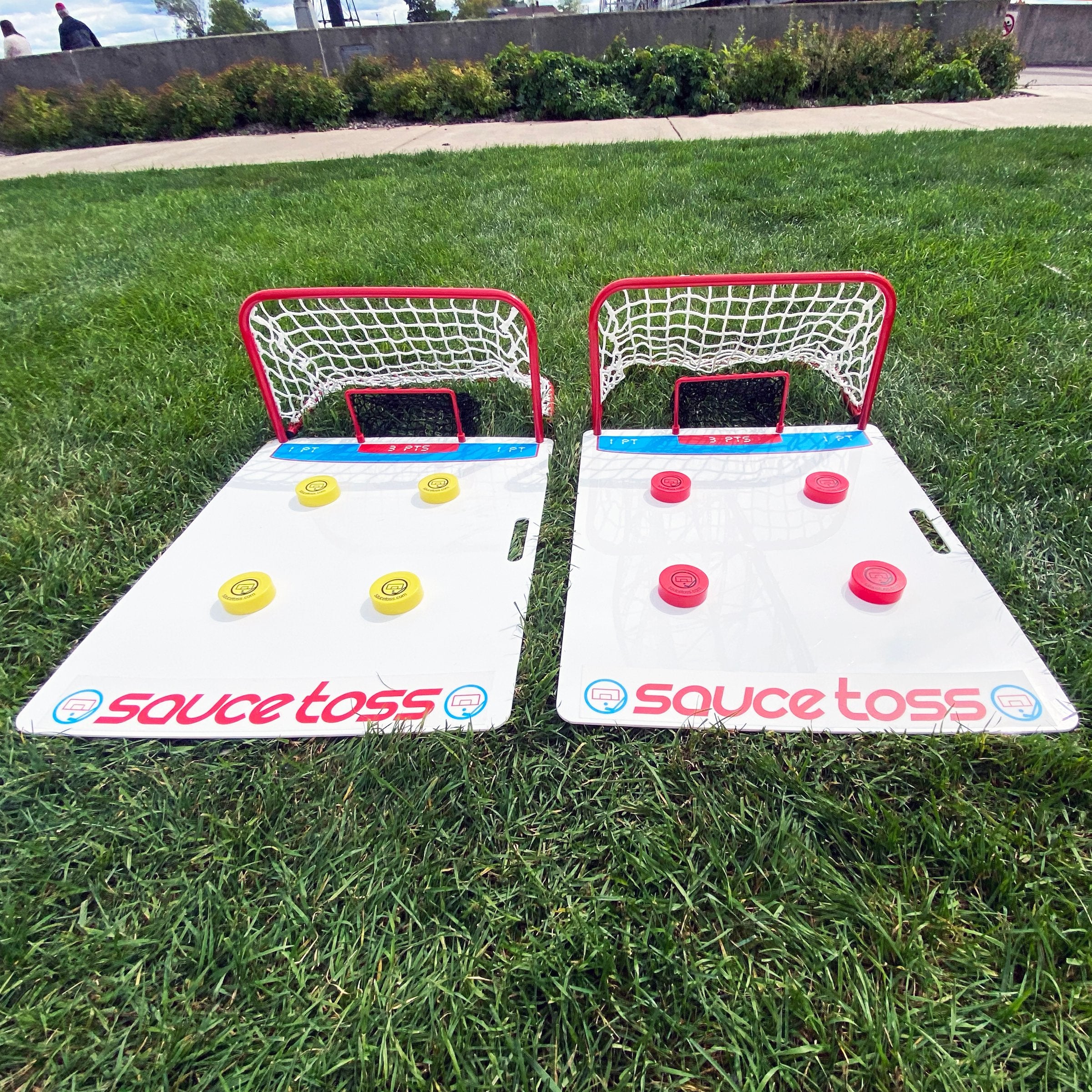 Two Sauce Toss Nets laying in the grass