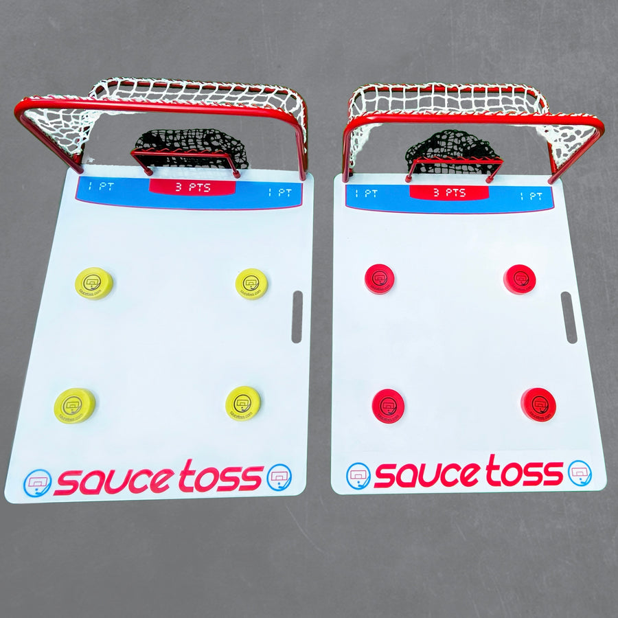 Two boards with puck and nets on top known as the Sauce Toss Pro